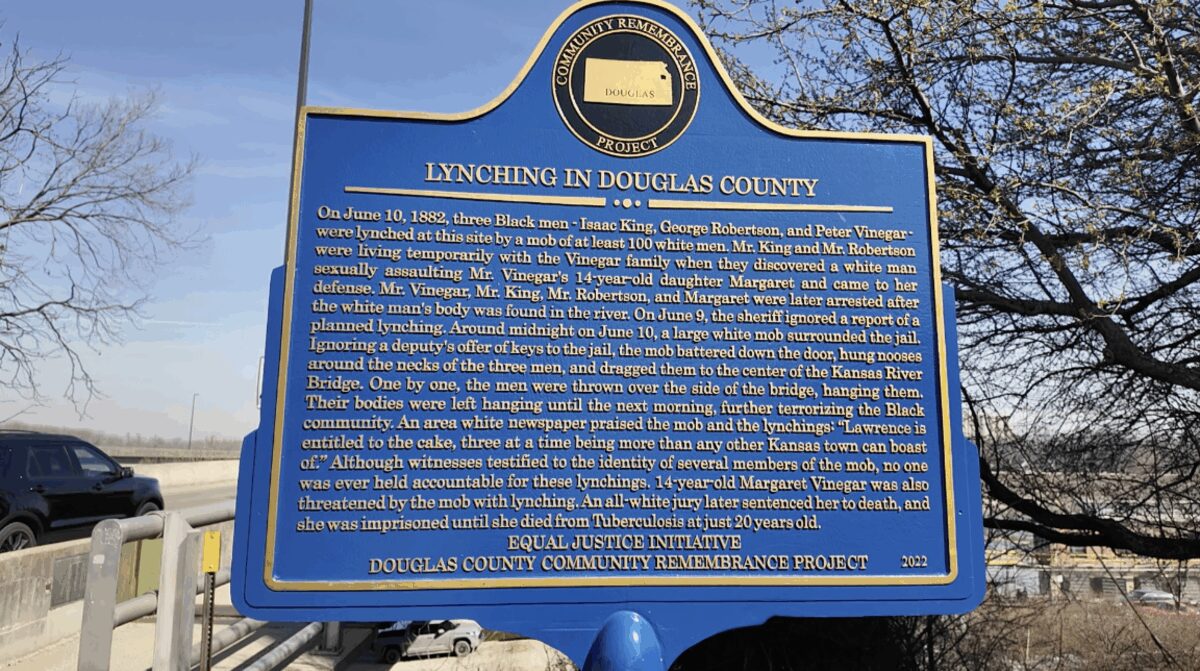 An Equal Justice Initiative sign marks the location of where three lynchings took place in Lawrence in 1882 at the bridge that runs over the Kansas River.