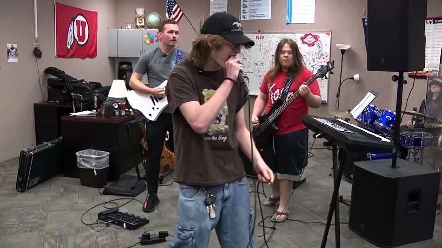 Two students are seen playing music alongside their teacher Brandon Lupus at Diamond Ridge High School.