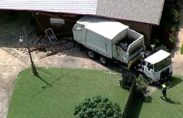 A garbage truck broke free while being towed Friday afternoon and rolled into a Dallas home