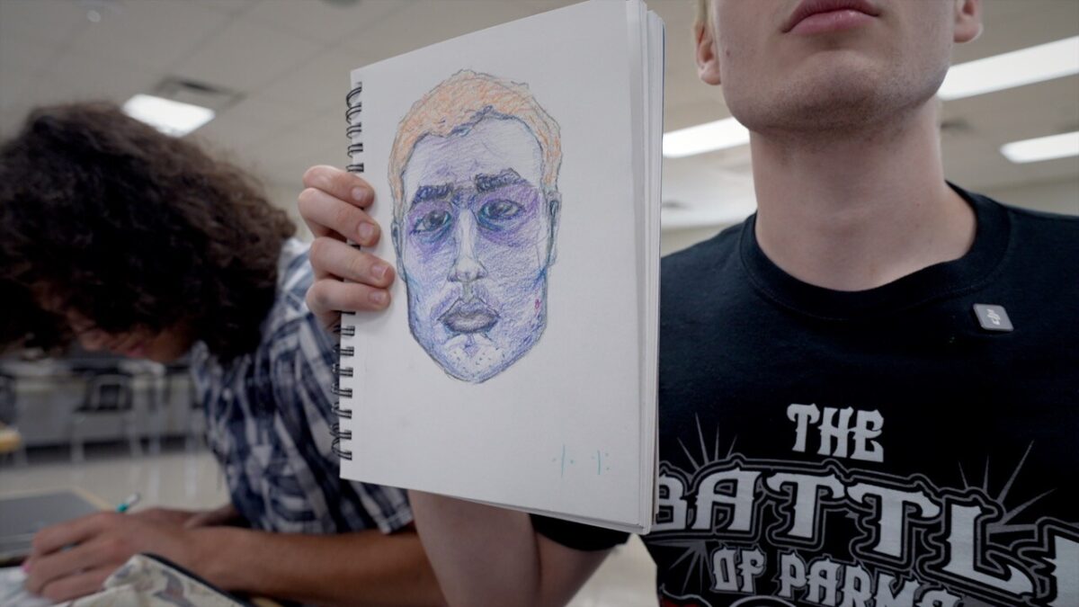 Allias Harman holds up a self-portrait he sketched in about 30 minutes at Butler Tech School of the Arts. Harman and other student artwork is going to be displayed this summer at Elementz