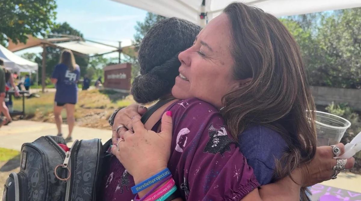 Heather Dearman (right) hugs one of the attendees at Saturday's event