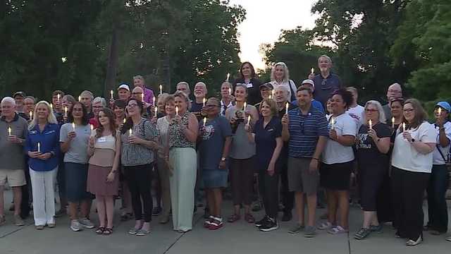 About 50 people attended a candlelight vigil organized by Rotary districts in Missouri and Kansas. Organizers said the event honored survivors