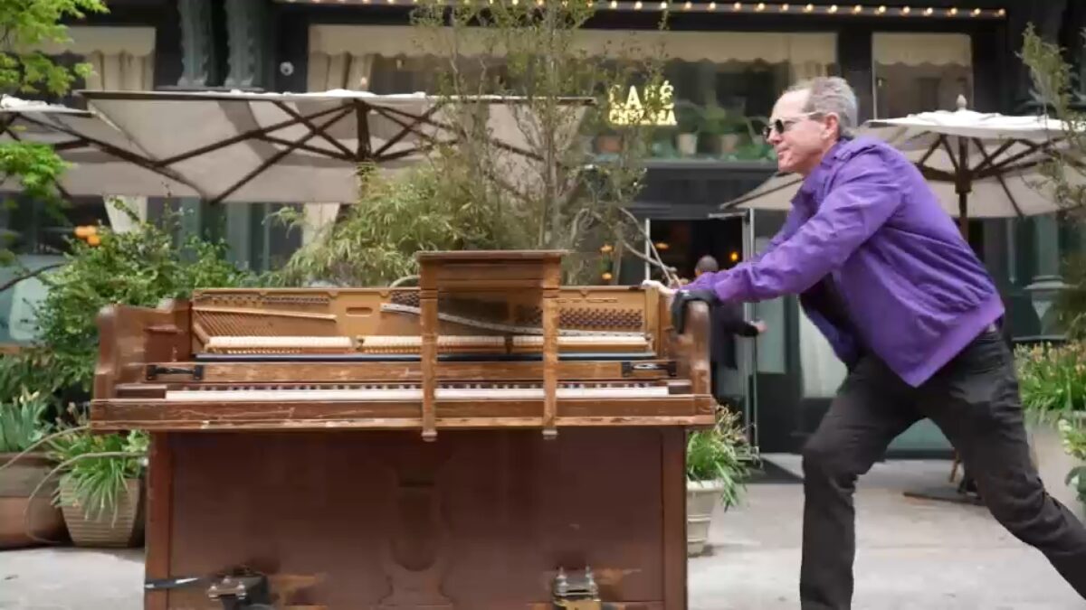 Spending a day with Kristopher Hull is a little like stepping into a movie. As he pushes and plays a 500-pound piano through the streets of New York City