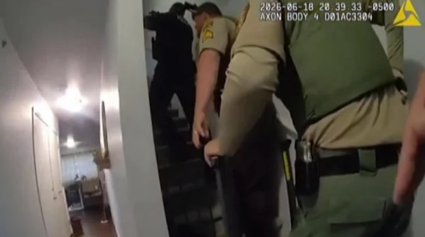 A still image from an officer's body camera footage showing the moment a gunman fired at law enforcement inside a St. Peter residence on June 18