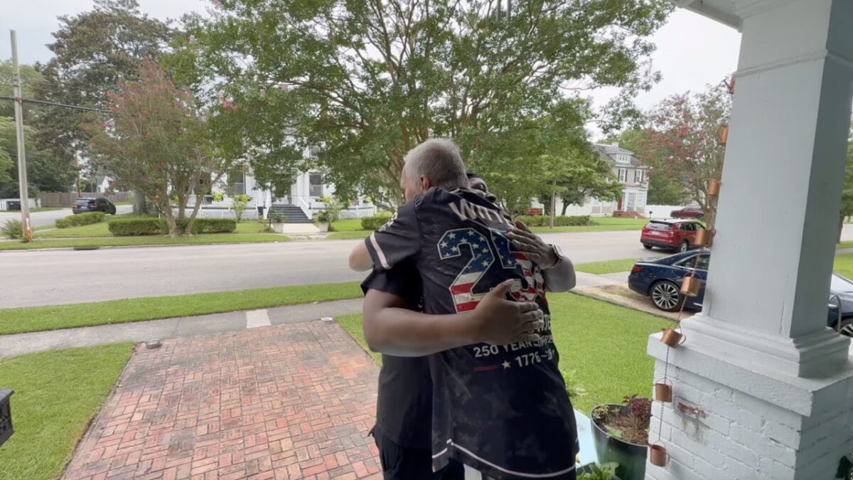 Tony Winslow and Carl Witten hug as they see each other for the first time since that night.