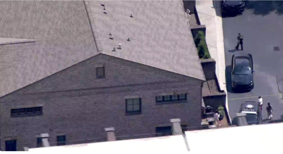 The brother of a current Baltimore Ravens and former Atlanta Falcons player has been charged in the death of their mother after police say an elderly woman was found dead inside a Buckhead-area townhome Tuesday afternoon.