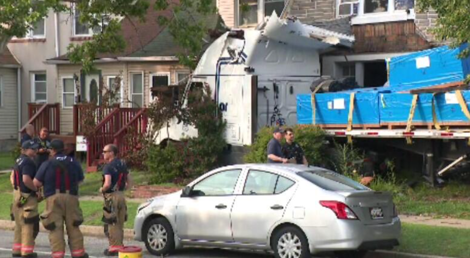 A tractor-trailer crashed into several homes and a light pole in Dundalk
