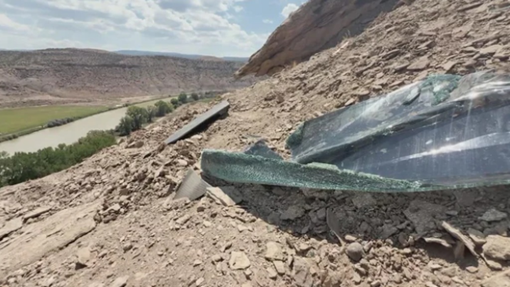 Debris can be seen at the cliffside crash scene on Monday in Orchard Mesa.
