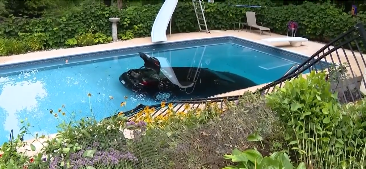 Car plunges into backyard pool.