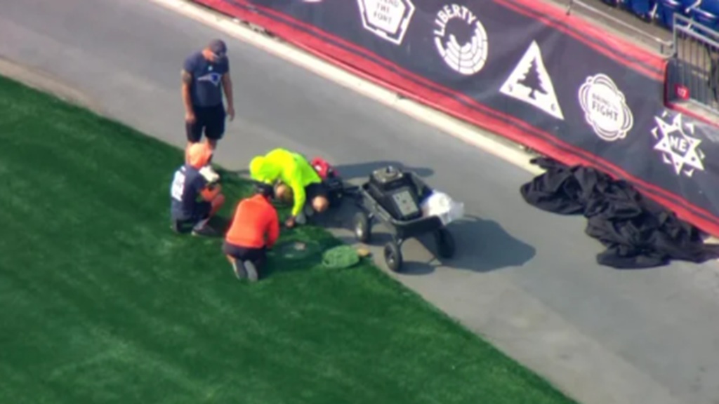 Crews work to replace artificial turf at Gillette Stadium on August 10.