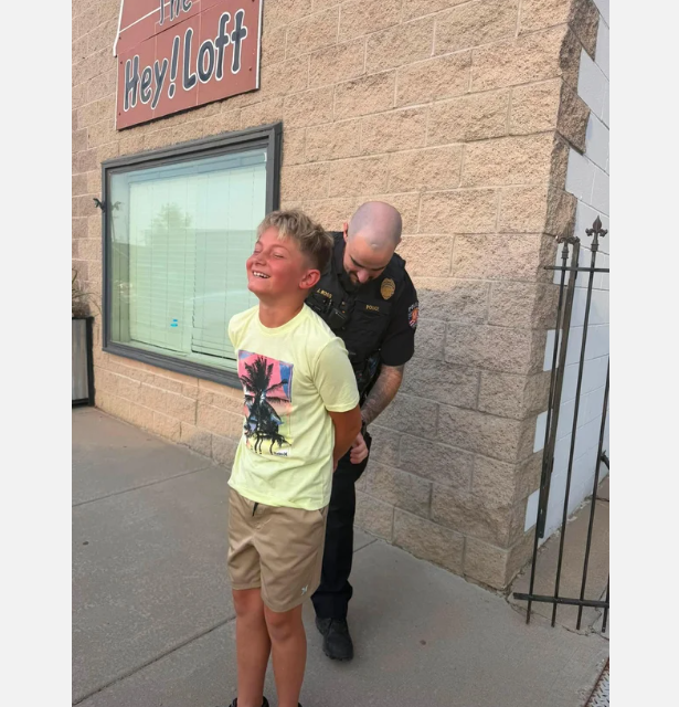 Keenesburg Police Officer Jack Ross takes Colton Stolz into custody Monday morning Stolz allegedly refused to let his mother take a back-to-school photo before his first day of 5th grade.