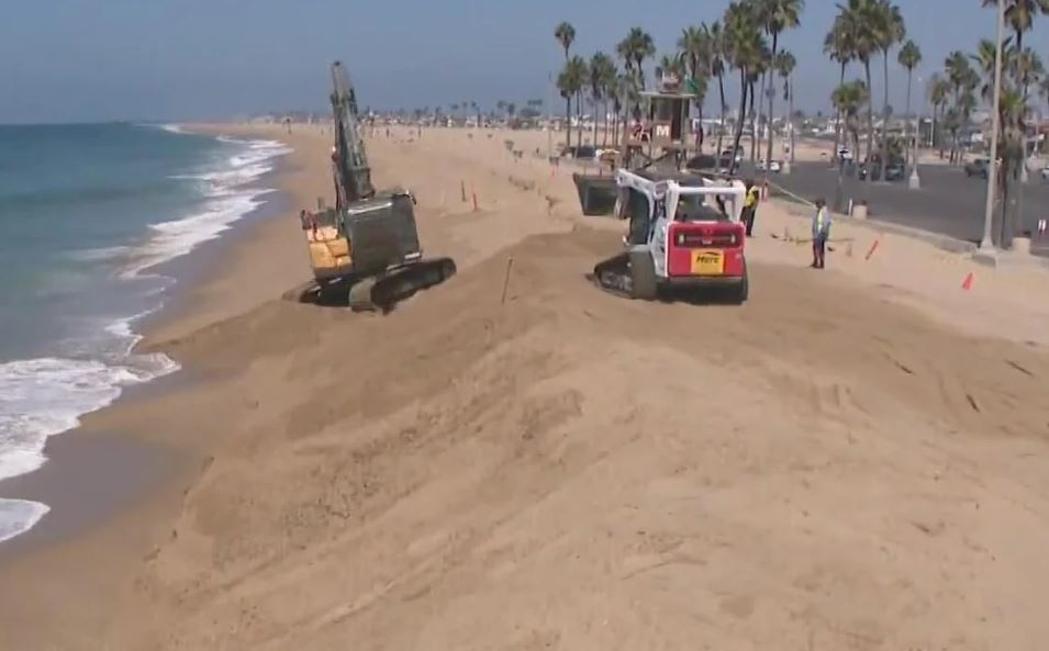 The city of Newport Beach is rushing to build berms on both sides of Balboa Pier to protect the land from potential impacts of Tropical Storm Marie.