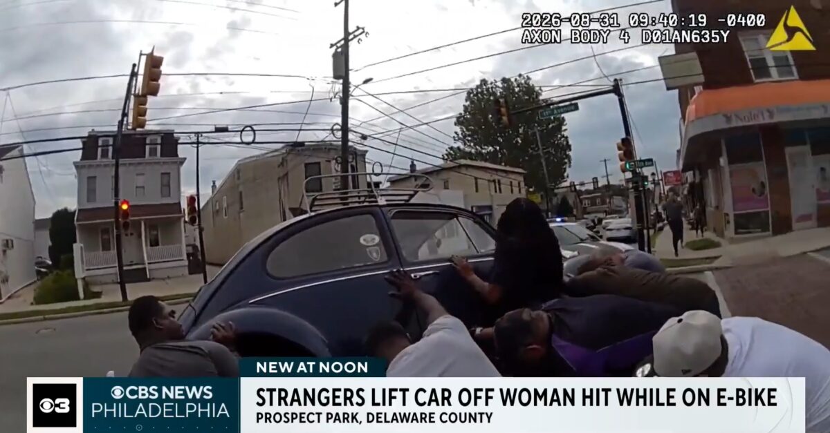 A woman riding an e-bike was pinned underneath a vintage Volkswagen Beetle after a crash — then a group of good Samaritans sprang into action to lift the car and rescue her.