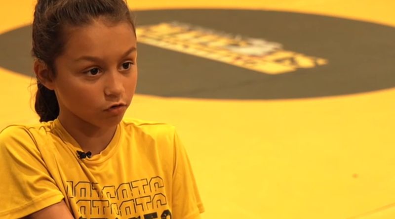 Grace Tiefel removes her cochlear implants before every match