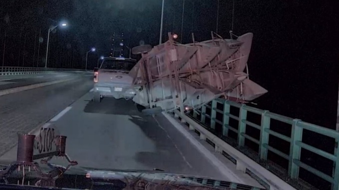 Michigan State Police said a canoe trailer tipped over the side of the Mackinac Bridge on Saturday night